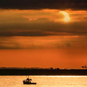 Partial Solar Eclipse Over a 1,000 foot lake freighter on Lake Superior by Jeff Blank 